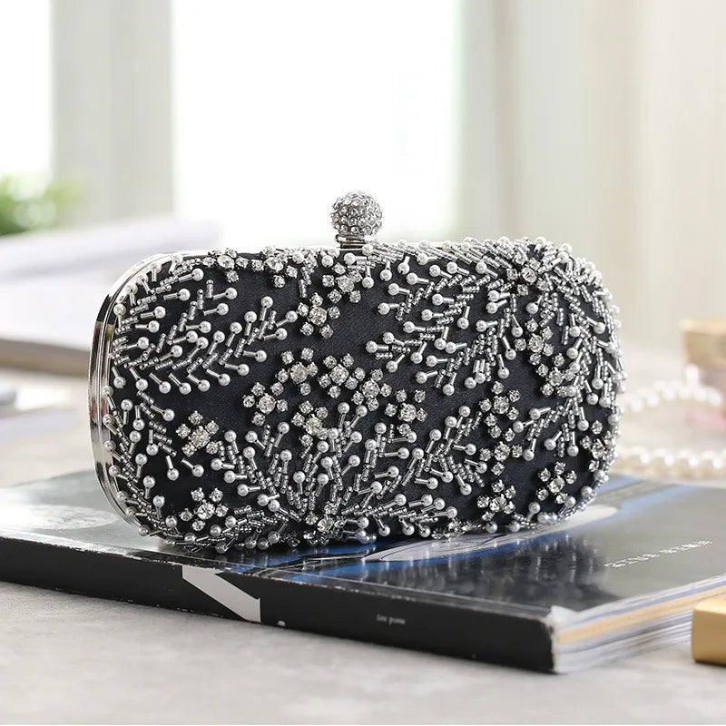 VaultHaus black pearl embellished evening clutch bag with intricate silver beadwork on a table