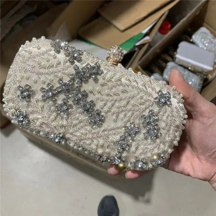 VaultHaus pearl embellished evening clutch bag with intricate floral beading held in hand