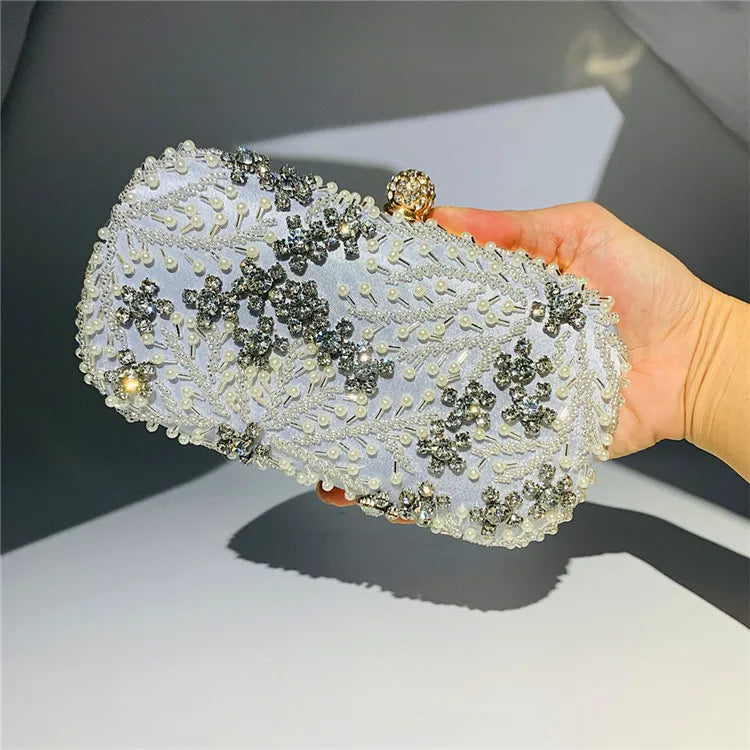VaultHaus pearl embellished evening clutch bag with intricate beaded floral design held in hand