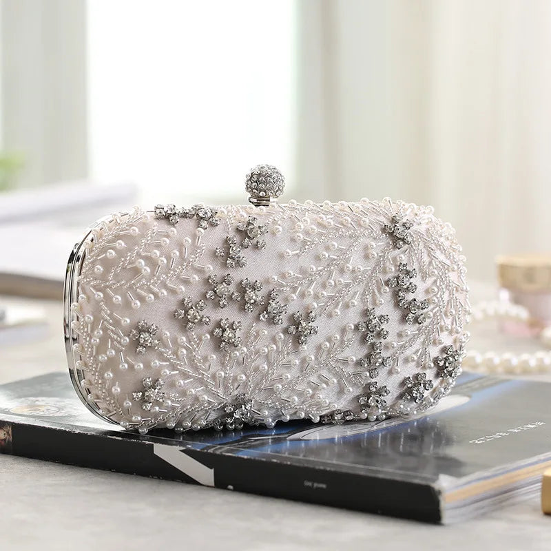 VaultHaus pearl embellished evening clutch bag with intricate bead and crystal details on white fabric