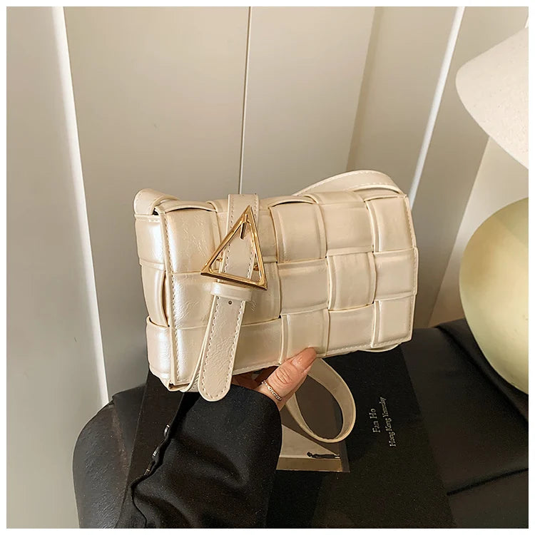 VaultHaus women's designer shoulder bag in cream woven leather with gold triangle buckle