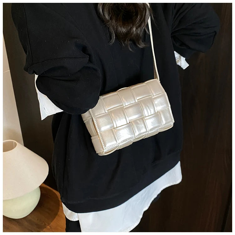 VaultHaus women's designer shoulder bag in cream with quilted pattern worn over black outfit