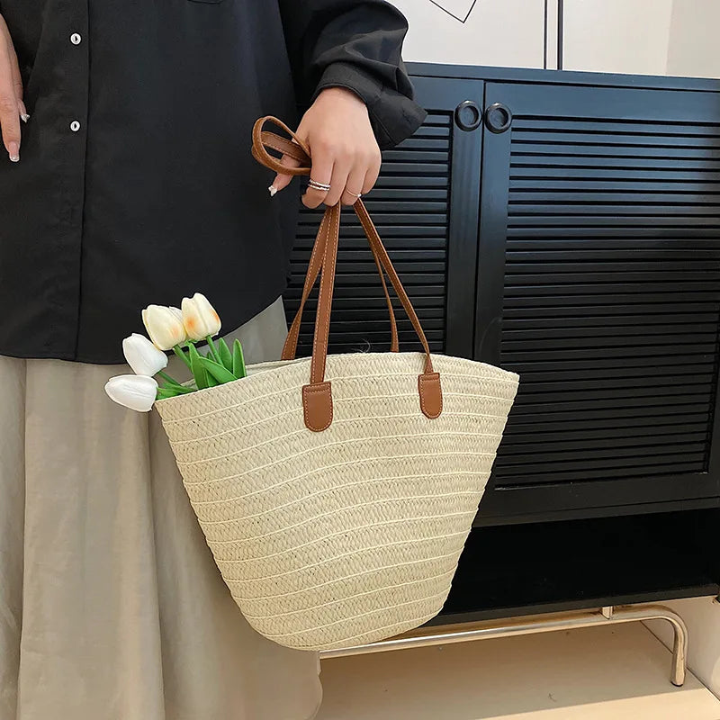 VaultHaus luxury woven shopper tote in cream color with brown leather handles and flowers inside