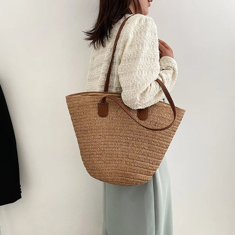 Stylish woman carrying a luxury woven shopper tote with leather handles, perfect for everyday use