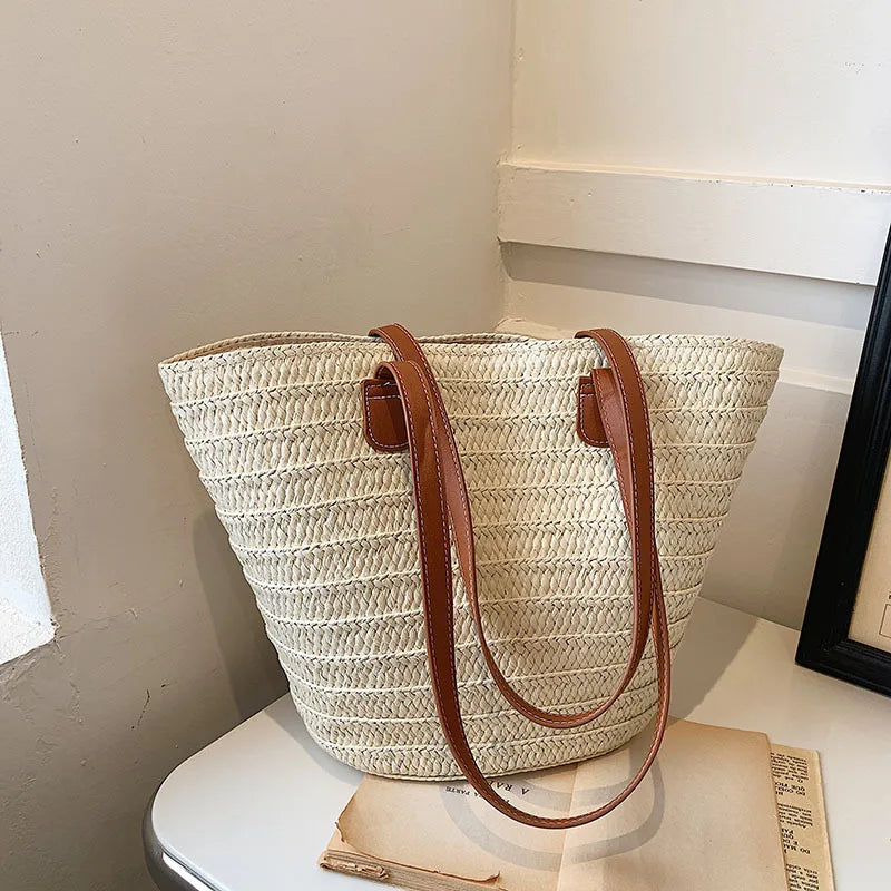 Stylish luxury woven shopper tote with brown leather handles, perfect for everyday use