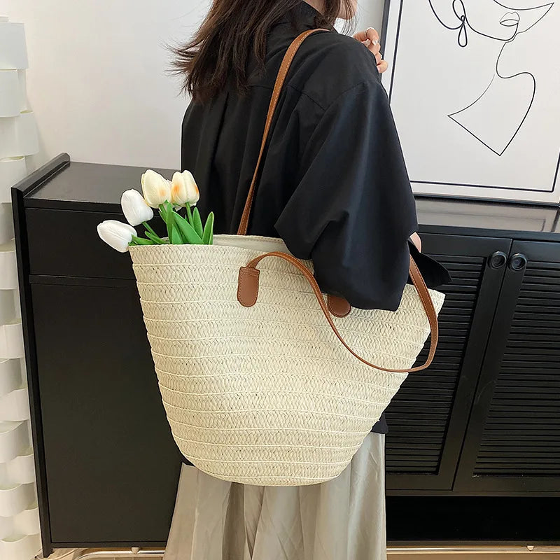 Elegant VaultHaus luxury woven shopper tote with leather handles, styled with fresh tulips