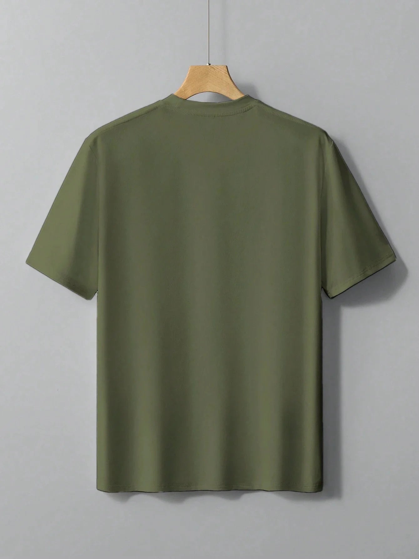 Men's cotton summer graphic print bear t-shirt in olive green hanging on a wooden hanger
