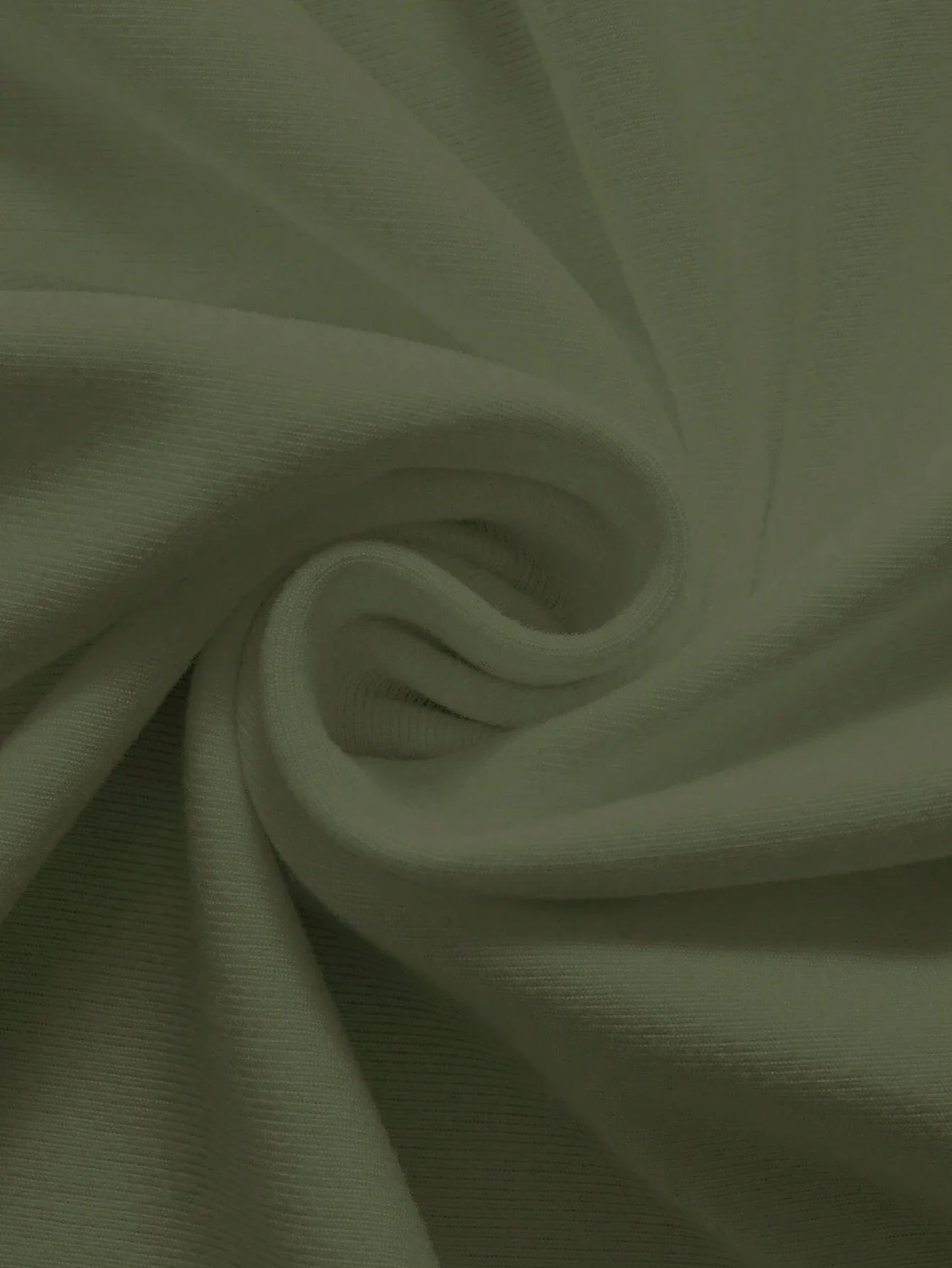 Close-up of soft fabric showing texture of men's cotton summer graphic print bear t-shirt in light green color