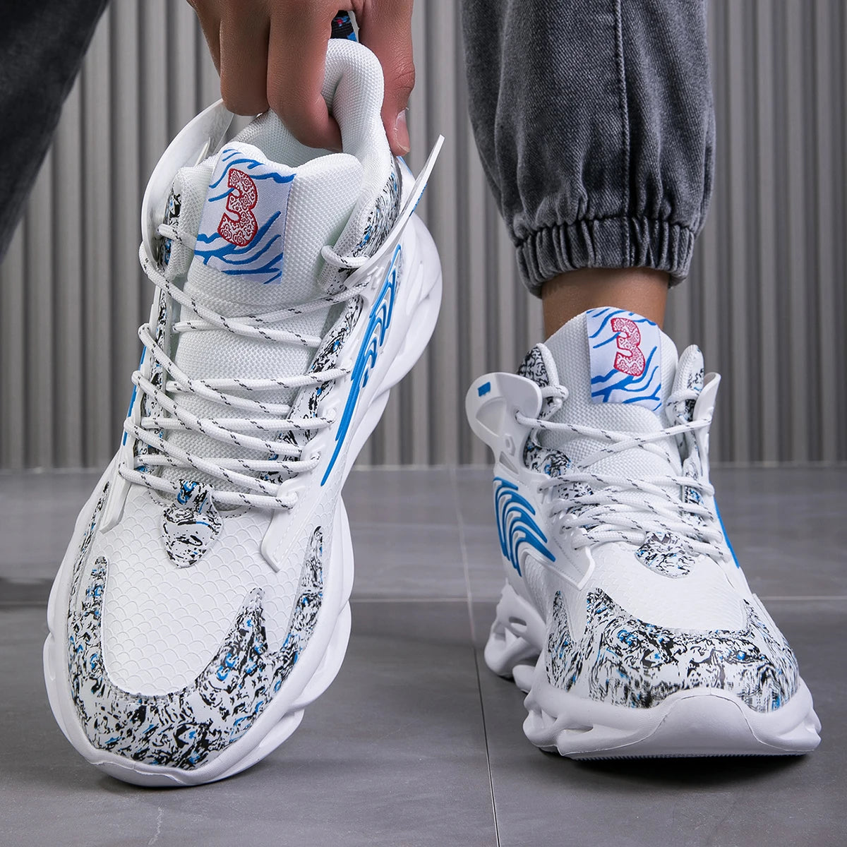 VaultHaus men's luxury sneakers in white with blue and black patterns and textured sole