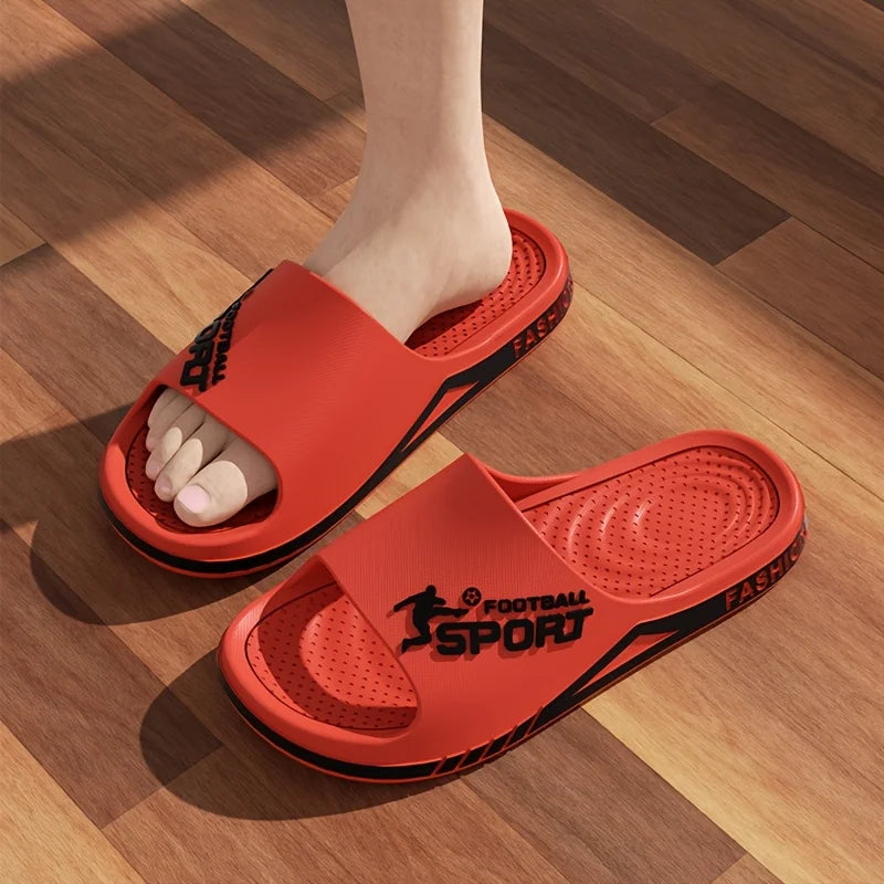 VaultHaus men's outdoor sports slides in red with black accents worn on wooden floor