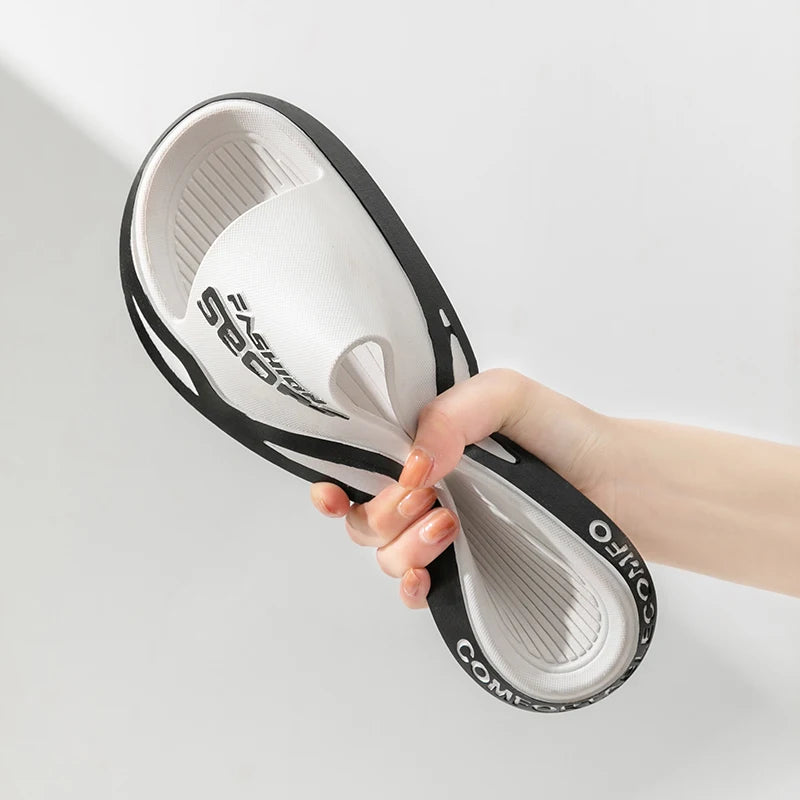 VaultHaus men's outdoor sports slides in white and black being flexed for comfort and flexibility