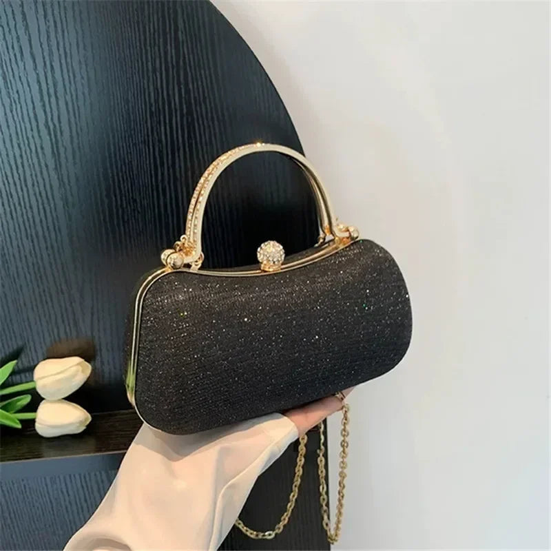 Elegant rhinestone evening bag with a gold frame and chain strap, perfect for special occasions