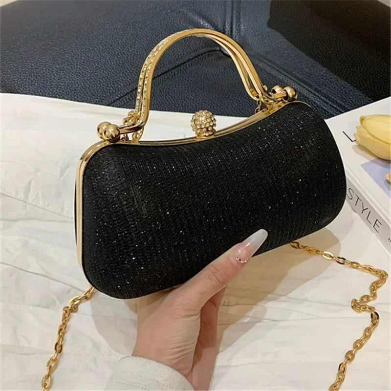 Elegant black rhinestone evening bag with a gold frame and chain strap for glamorous occasions