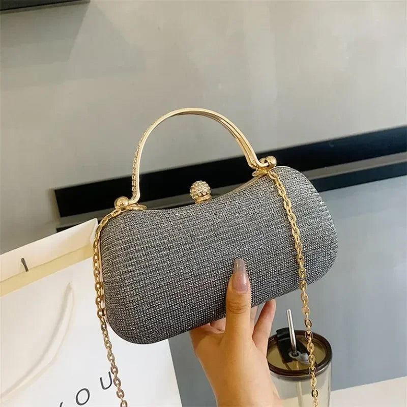Stylish grey rhinestone evening bag with a gold chain and clasp for elegant occasions