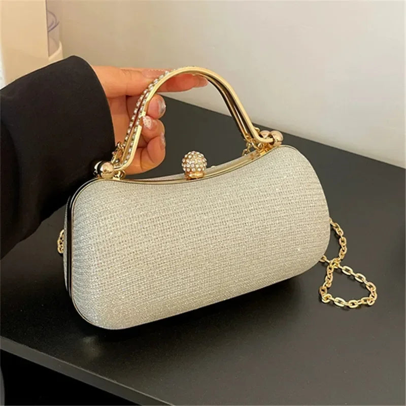 Elegant rhinestone evening bag with pearl clasp and gold chain for stylish occasions