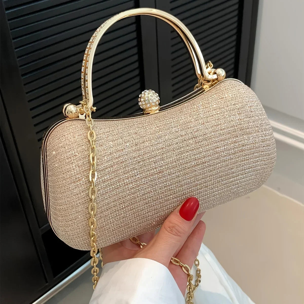 Elegant rhinestone evening bag with a gold chain strap and pearl embellishments for formal occasions