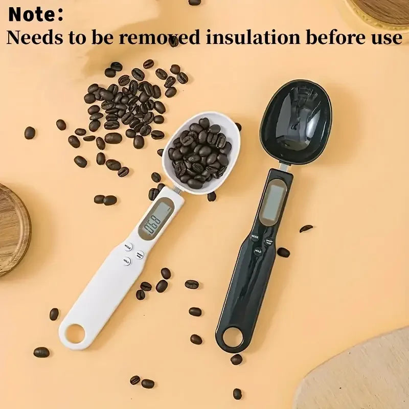 Mini electronic spoon scale in white and black measuring coffee beans for precise kitchen use