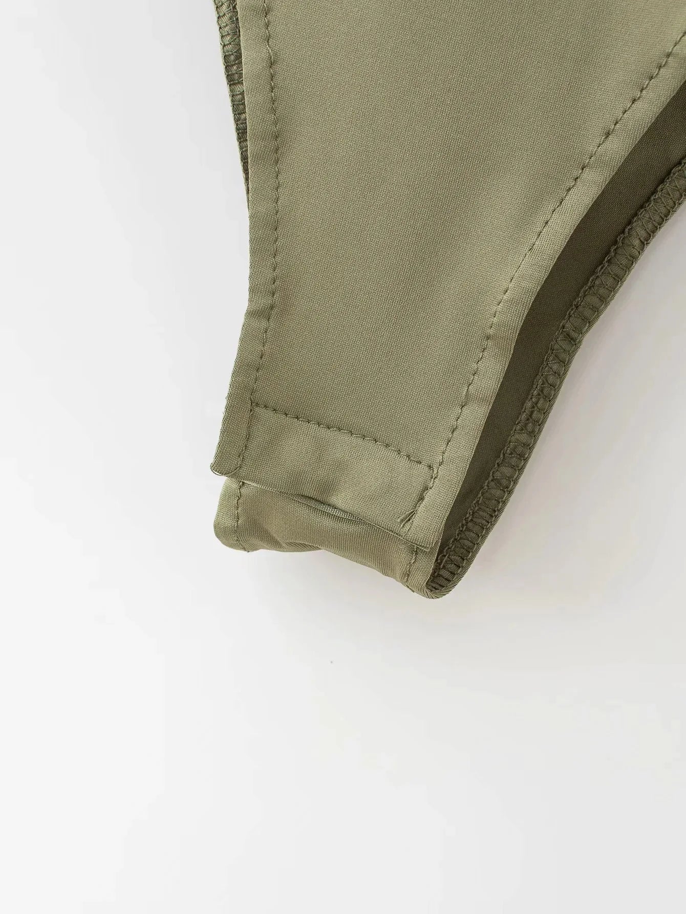 Close-up of the summer slim bodysuit hem detail in olive green color from VaultHaus