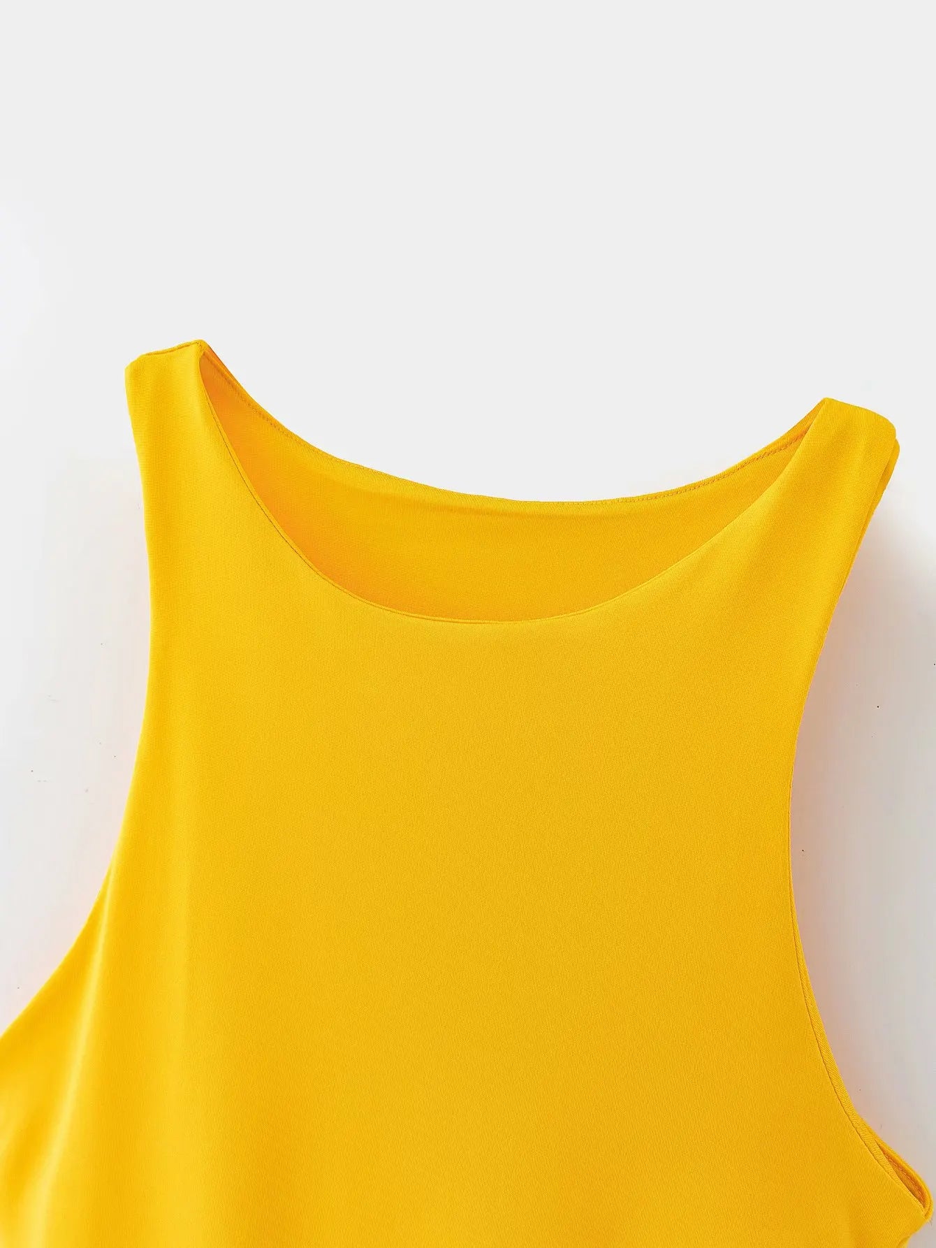 Close-up of a vibrant yellow summer slim bodysuit with a round neckline for stylish summer wear