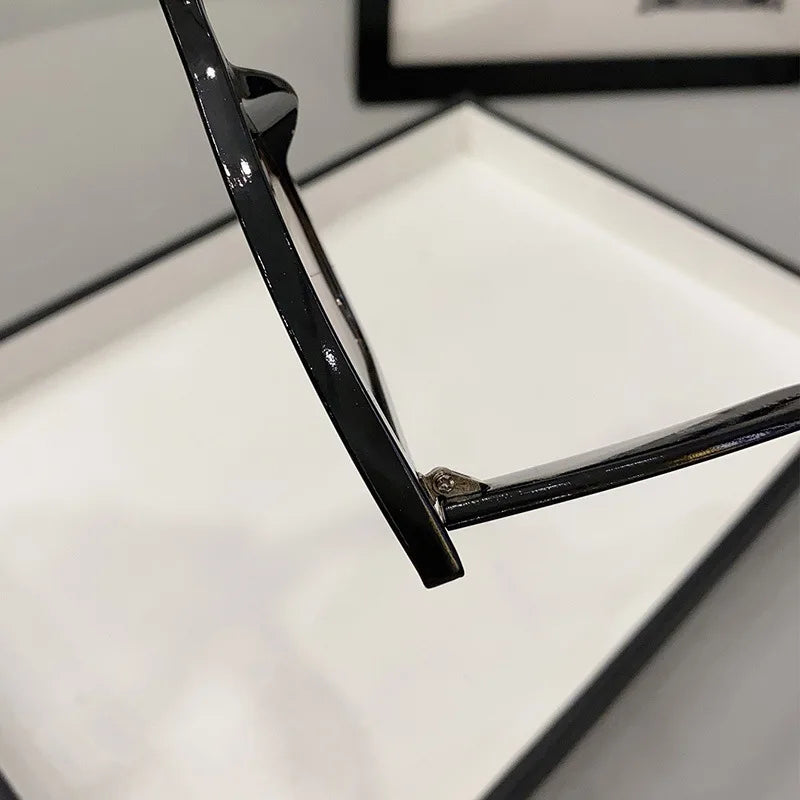 Close-up of black vintage cat eye sunglasses for women focusing on the frame hinge detail