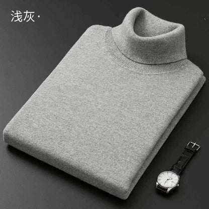 Grey men's cashmere cotton turtleneck jumper folded neatly with a watch beside it