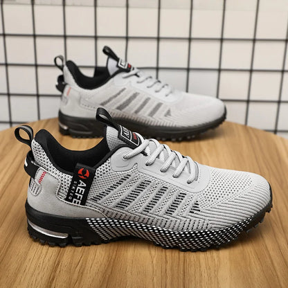 VaultHaus gray lightweight athletic sneakers for men with breathable mesh and black sole on wooden surface