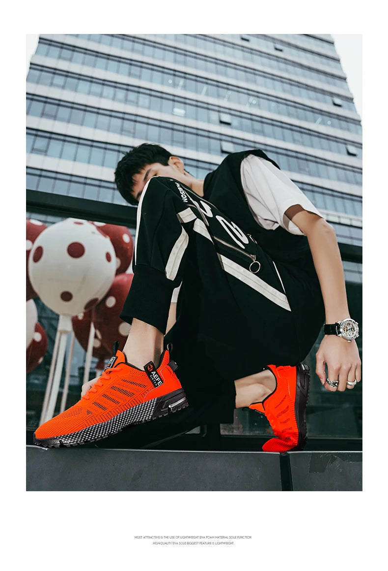 Men wearing bright orange lightweight athletic sneakers for men by VaultHaus in urban setting