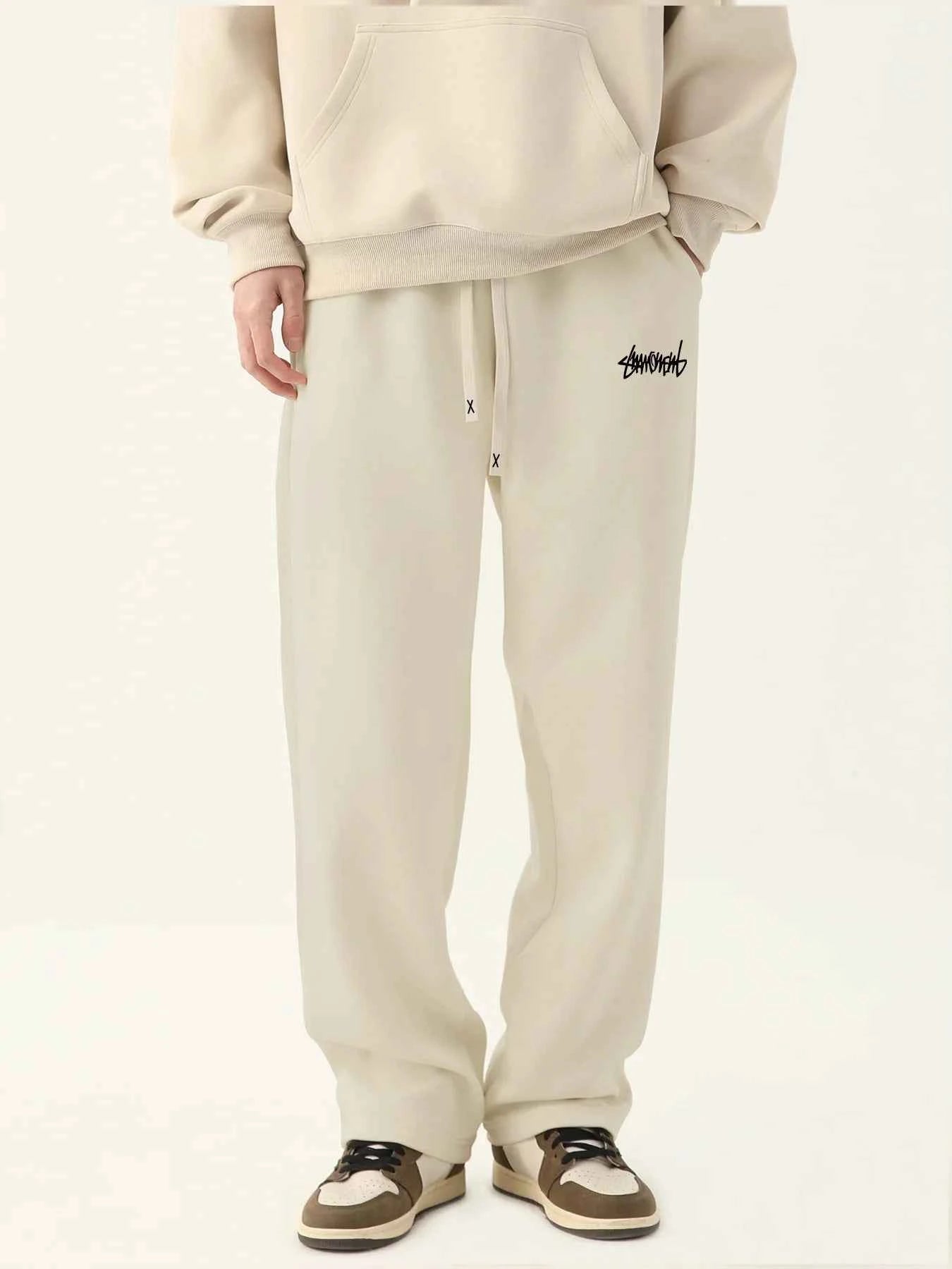 VaultHaus men's loose fit joggers in light beige with drawstring waist and logo detail