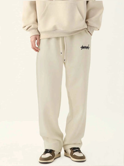 VaultHaus men's loose fit joggers in light beige with drawstring waist and logo detail
