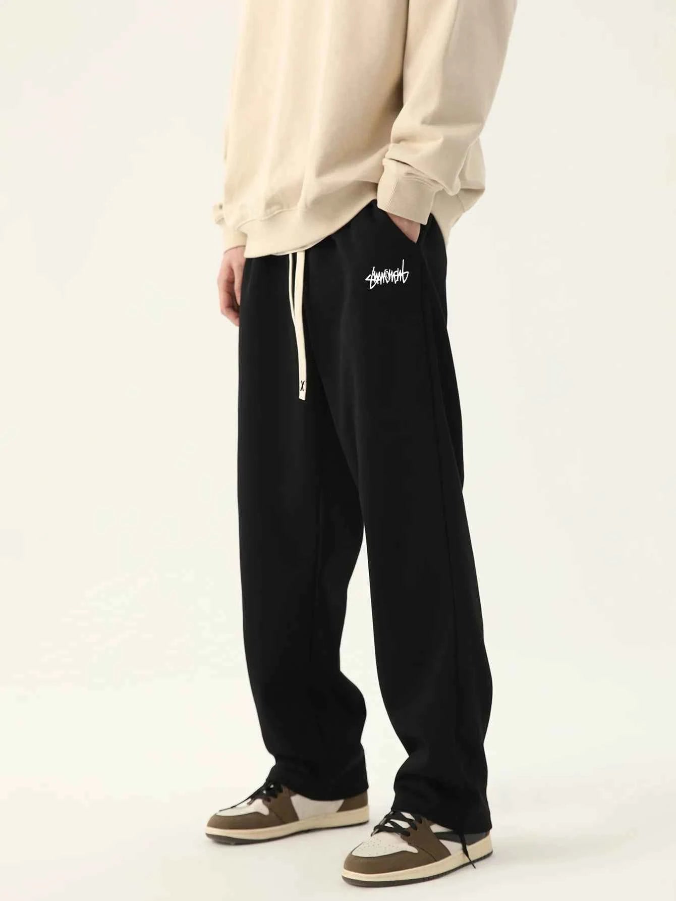 Men's loose fit joggers in black by VaultHaus, featuring side pockets and a comfortable waistband