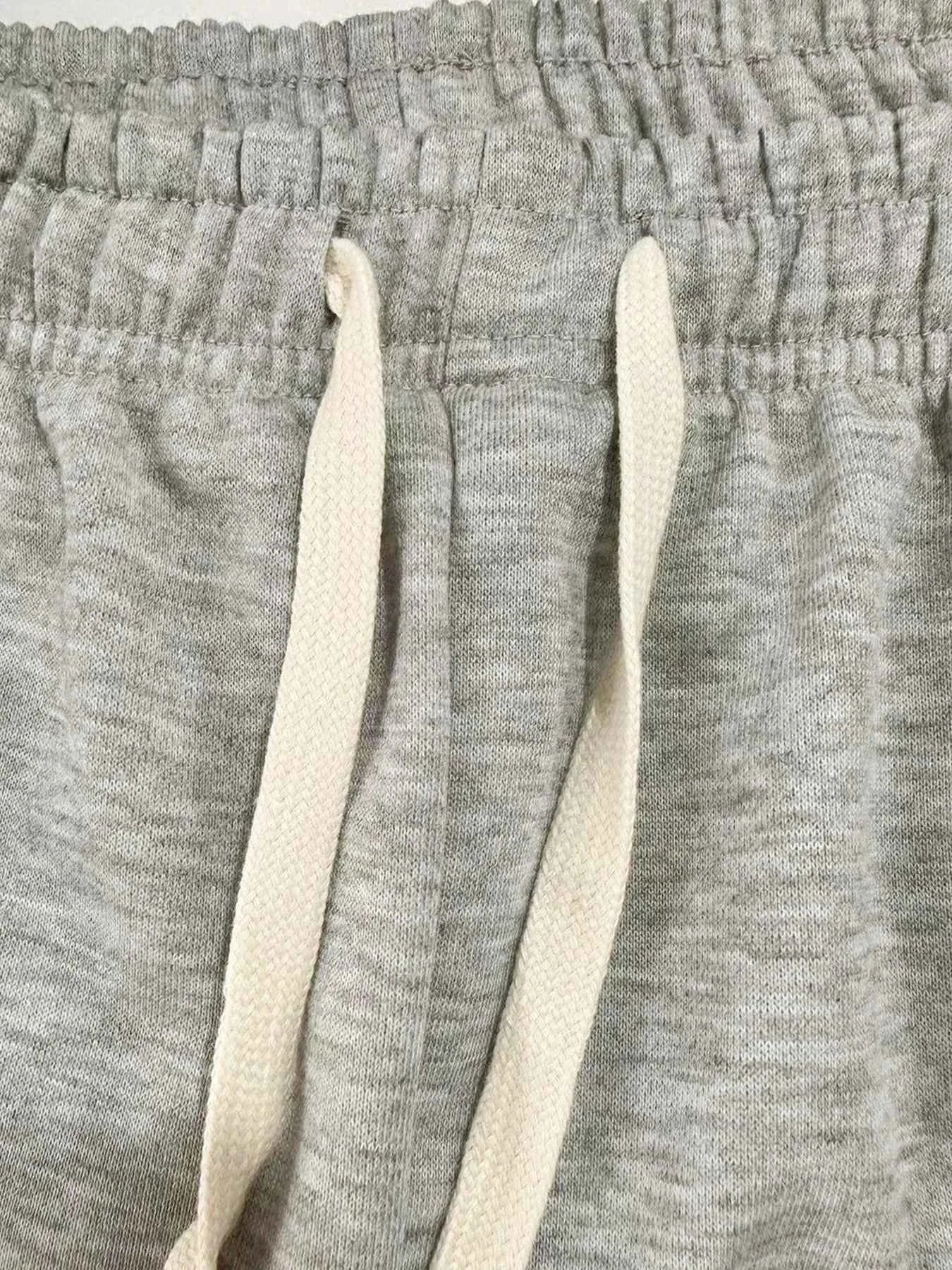 Close-up of VaultHaus men's loose fit joggers with adjustable drawstring waistband in grey