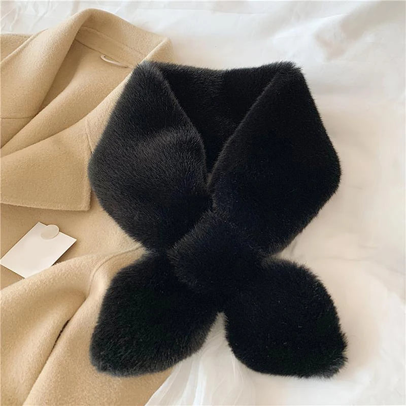 Elegant black cosy faux fur scarf for cold weather displayed on a soft cream coat