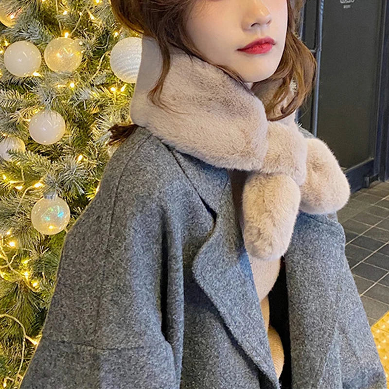 Stylish model wearing a cosy faux fur scarf for cold weather, paired with a grey coat and festive background