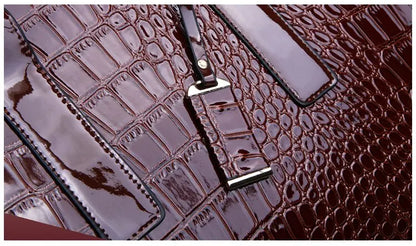 Elegant burgundy crocodile print tote bag with a glossy finish and stylish hardware details