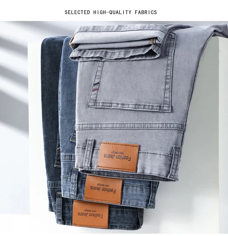 Stack of VaultHaus comfortable men's fashion jeans in grey and dark blue colors with quality fabric labels