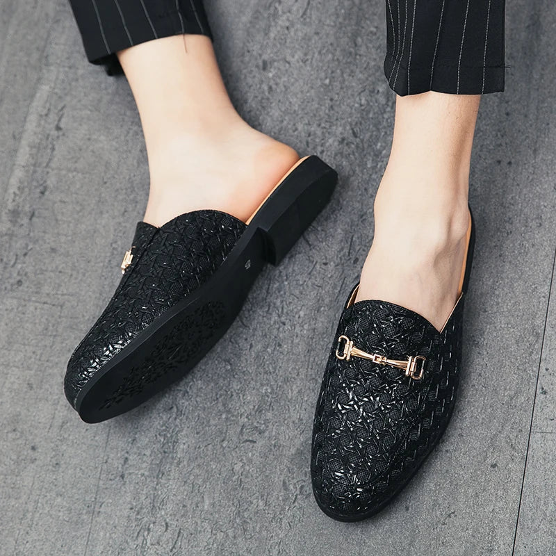 VaultHaus black fashion mules for men with textured pattern and gold buckle detail on grey floor
