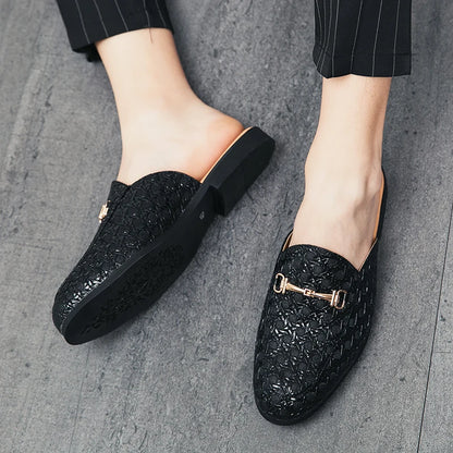 VaultHaus black fashion mules for men with textured pattern and gold buckle detail on grey floor