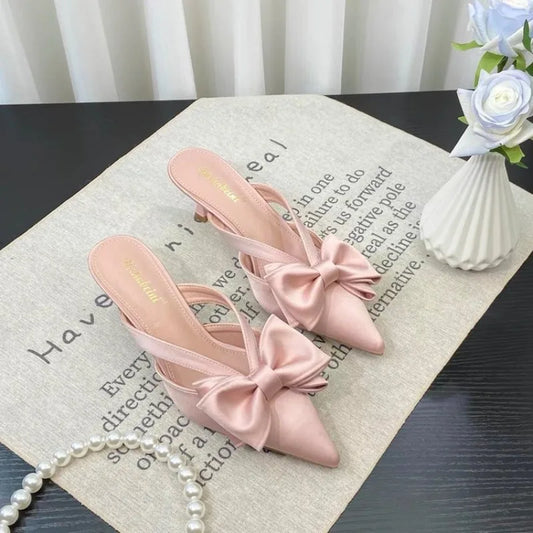 French style pink slippers with bow detail, perfect for stylish comfort indoors