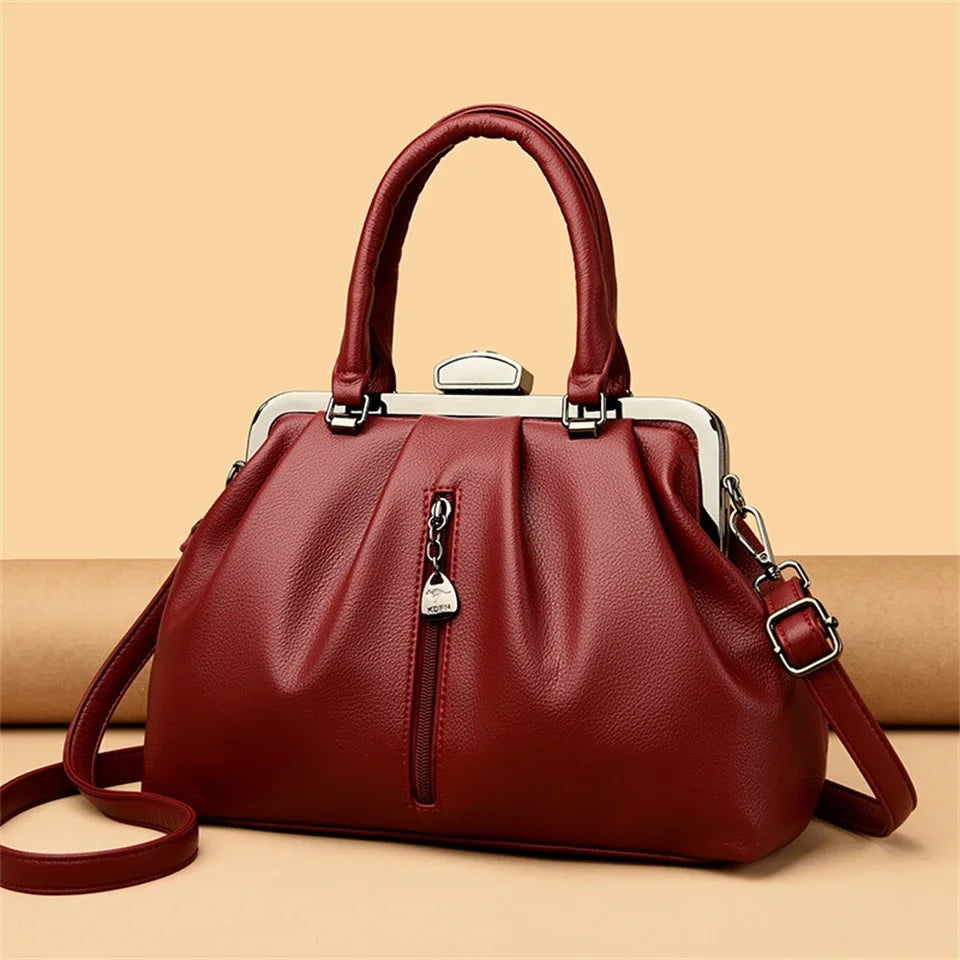 Stylish high quality PU leather handbag in deep red with a top handle and adjustable shoulder strap