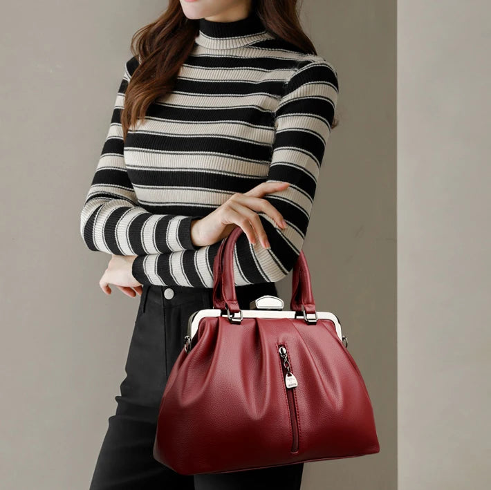 Fashionable woman holding a high quality PU leather handbag in deep red for stylish outings