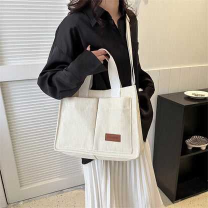Stylish large capacity canvas handbag in cream color, perfect for daily use and casual outings