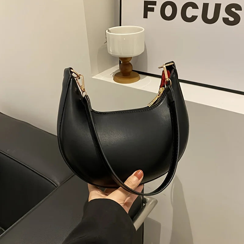 Stylish VaultHaus luxury moon-shaped handbag in black with a sleek design and gold hardware