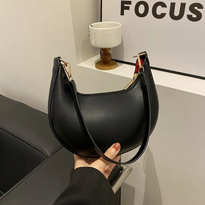 Stylish VaultHaus luxury moon-shaped handbag in black with a sleek design and gold hardware