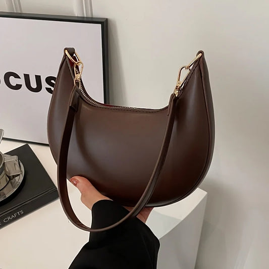VaultHaus luxury moon-shaped handbag in brown with a sleek design and shoulder strap