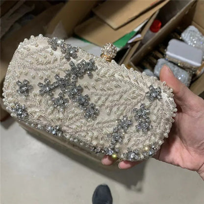 VaultHaus pearl embellished evening clutch bag with intricate floral beading held in hand