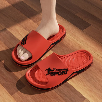 VaultHaus men's outdoor sports slides in red with black accents worn on wooden floor