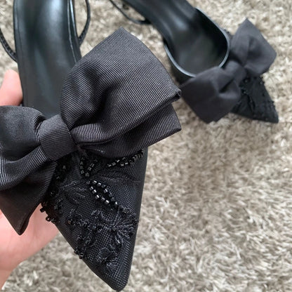 Black mesh embroidered high heels with bow featuring intricate details and elegant design