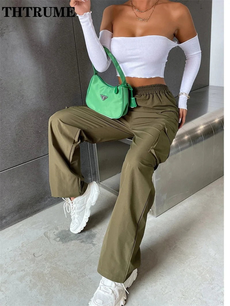 Trendy vintage streetwear cargo pants in olive green paired with a stylish top and green handbag