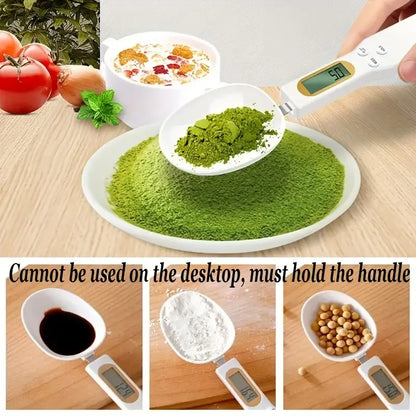Mini electronic spoon scale displaying 57 grams of green powder on a plate with kitchen ingredients in the background