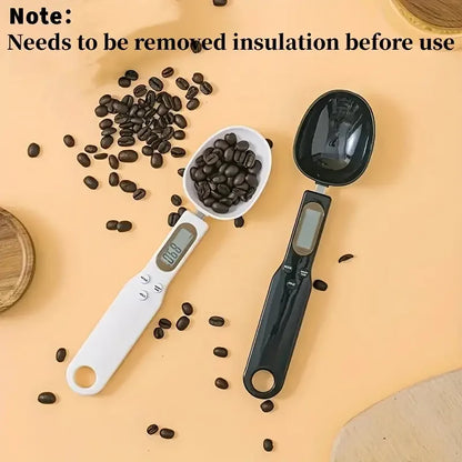 Mini electronic spoon scale in white and black measuring coffee beans for precise kitchen use